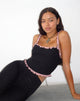 Imagen de Idalia Corset Top Negro con Volantes de Malla Rosa