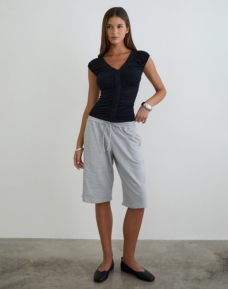 Imagen del top con cuello en V y fruncido de Atheia en jersey de rayón negro.