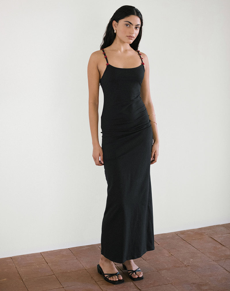 Maxivestido Cantana en negro con rosetón rojo