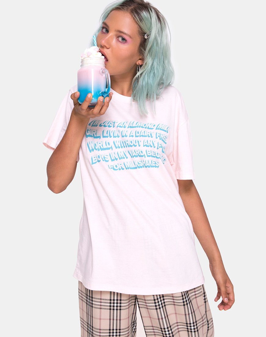 Image of Camiseta básica oversize en rosa suave con texto Almendra Leche Niña X Top Niña