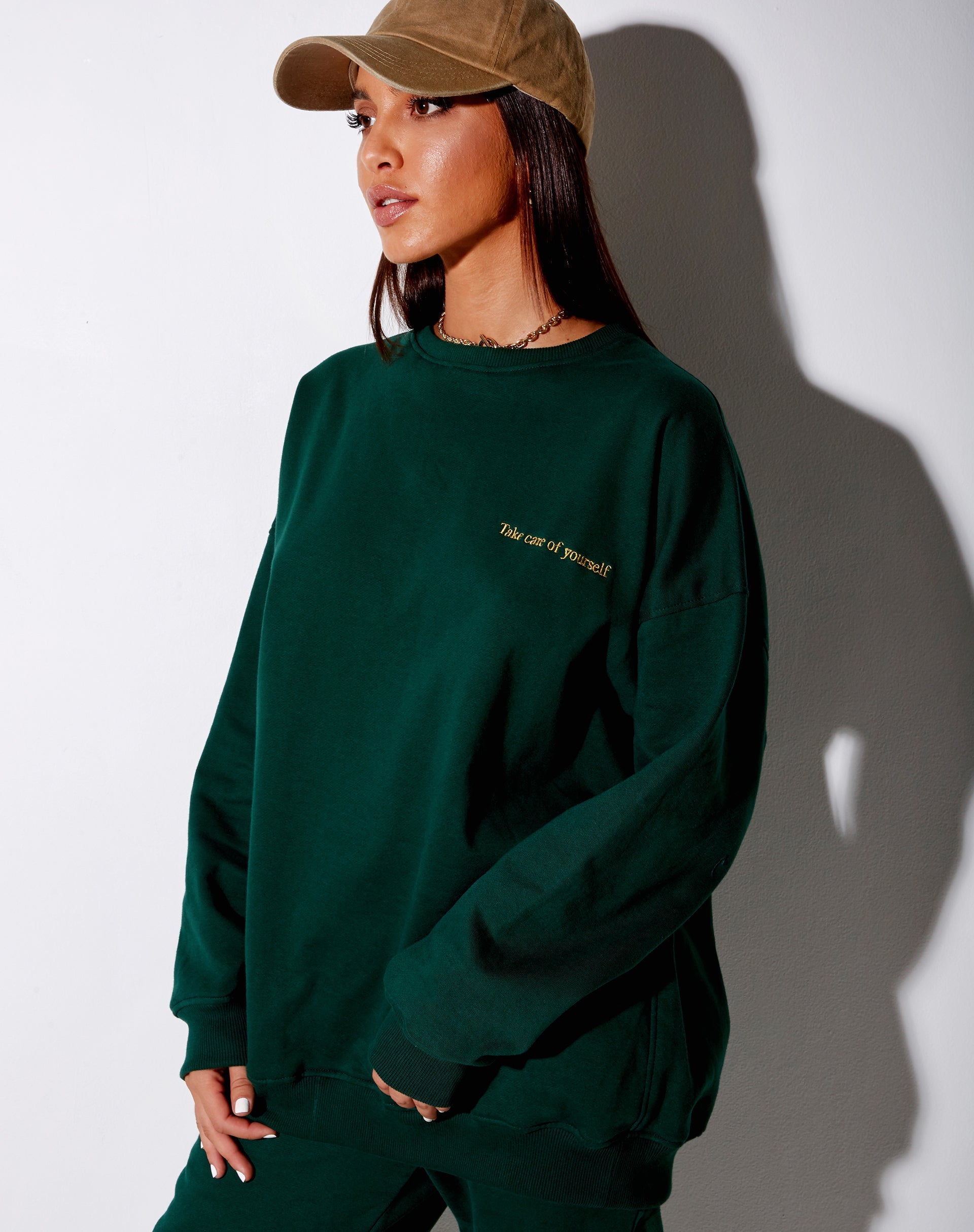 Imagen de sudadera Glo en verde botella con bordado Take Care Of Yourself